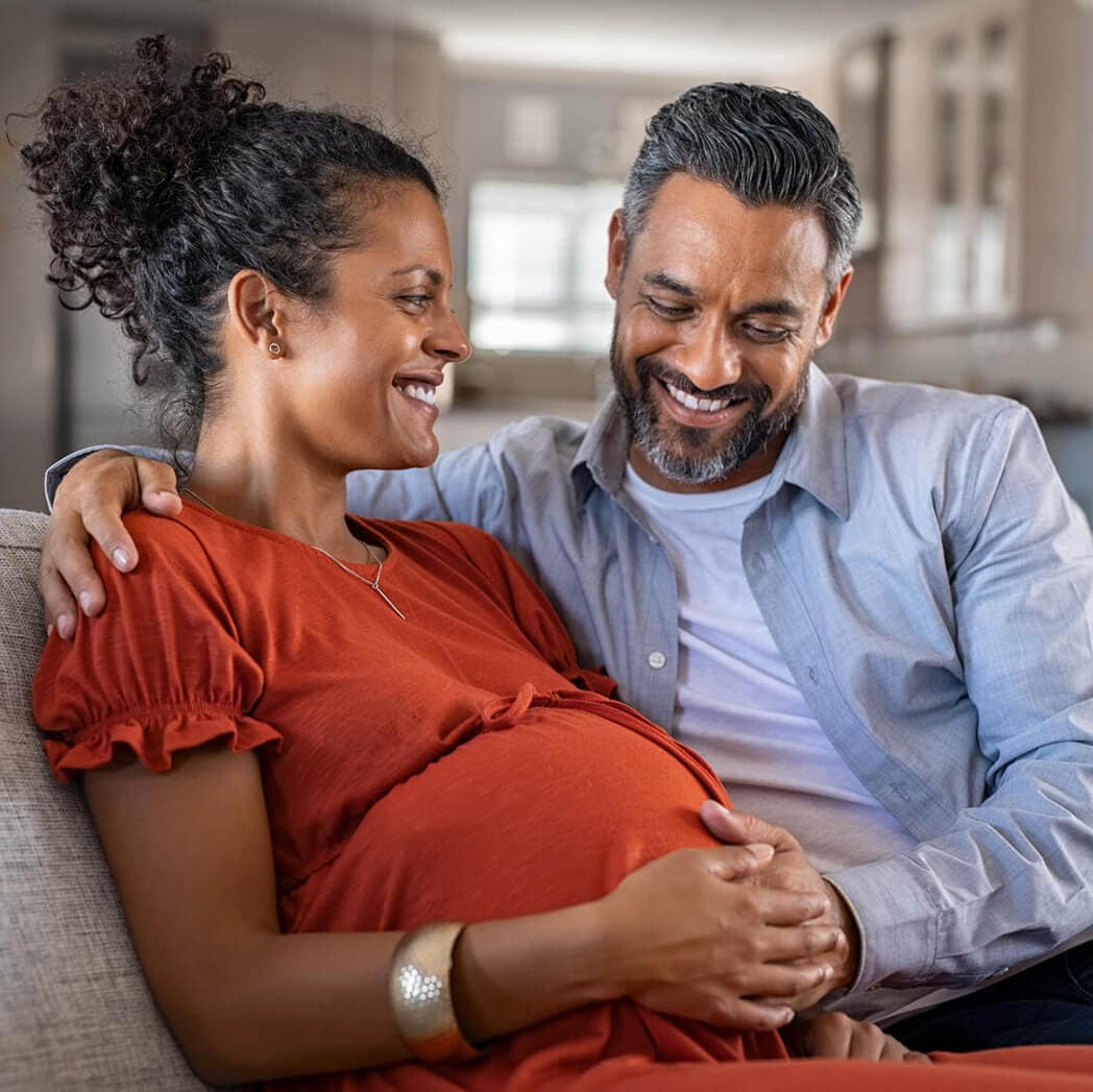 A smiling pregnant couple