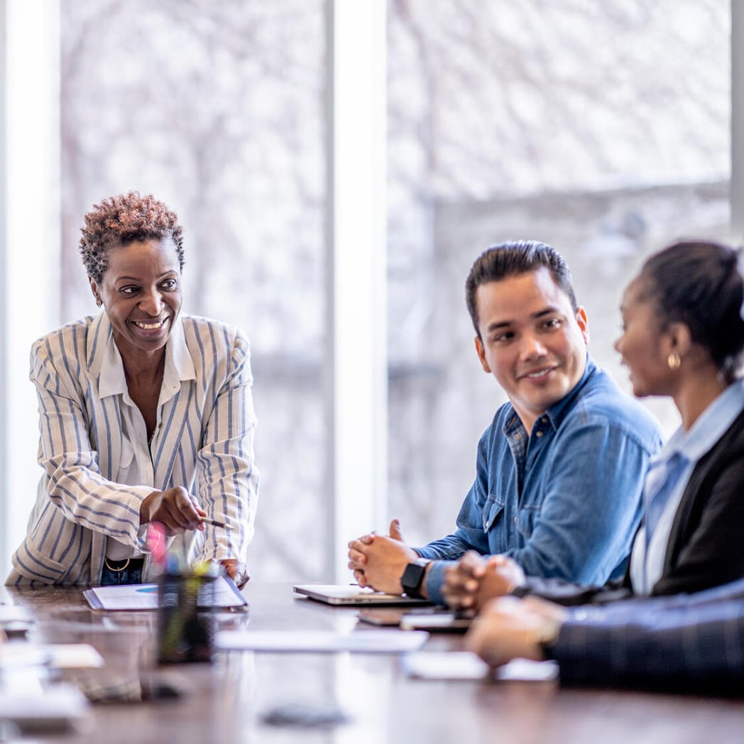 Executives collaborate around a table.